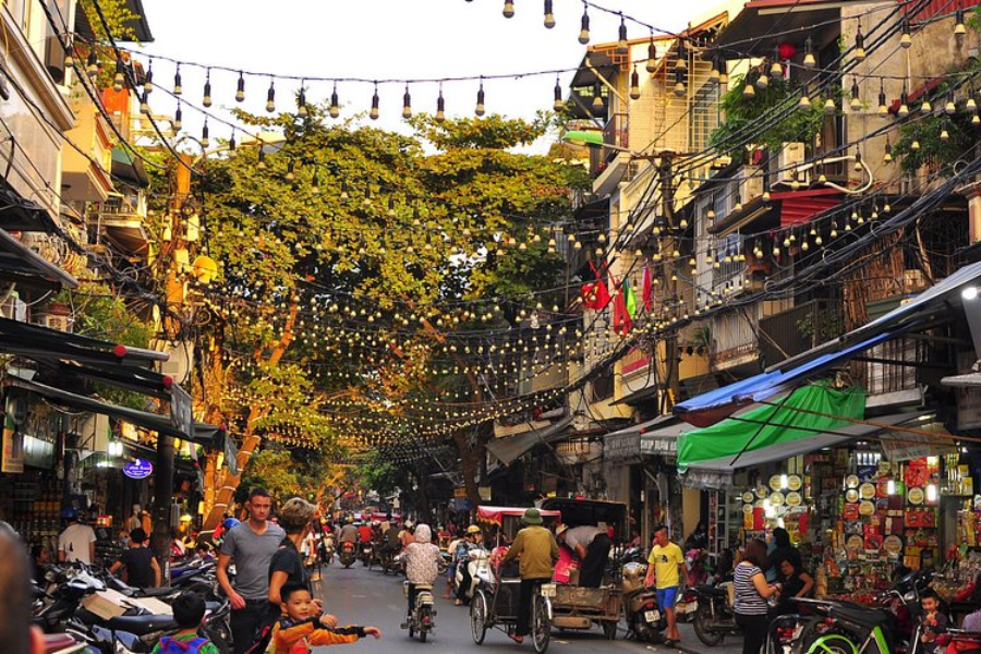 Travelers enjoying a private architectural walking tour near French-colonial yellow vill