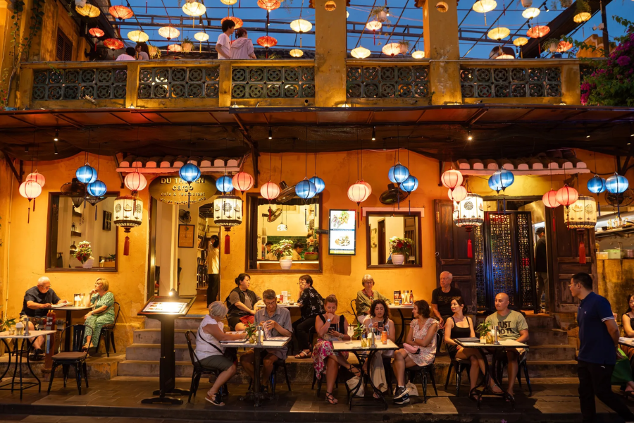 Luxury private balcony dining at a heritage wooden shophouse overlooking Hoi An lantern river view