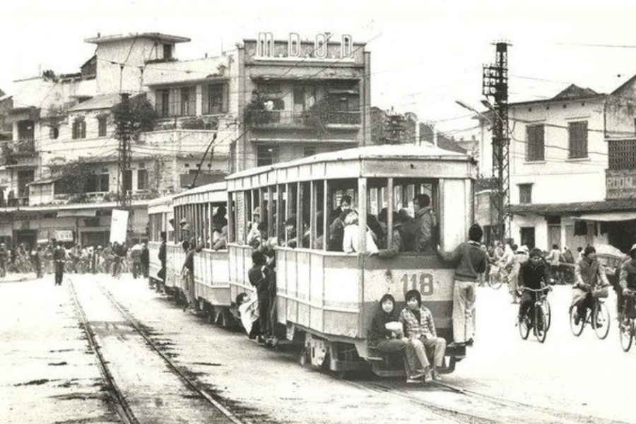 Single-track railway line built in 1902 running through narrow residential tube houses and leafy balconies in Hanoi Old Quarter