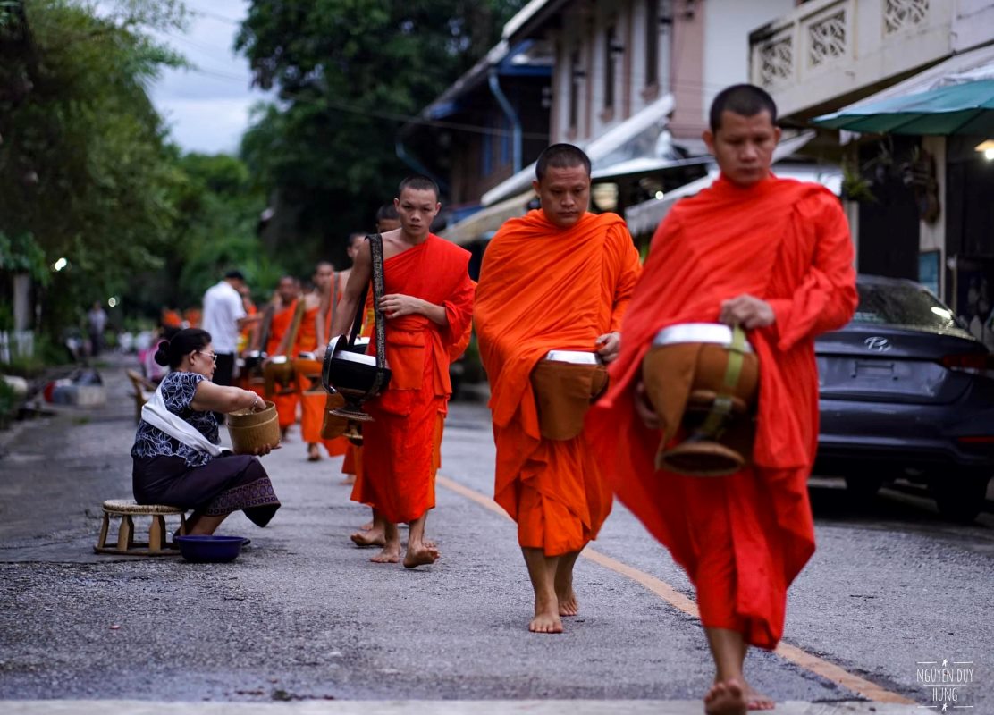 Local People Are Giving Food To The Monks On A Morning Alms Giving In Luang Prabang