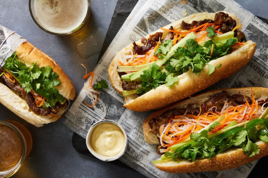 Vietnamese banh mi baguette filled with pork, pate, herbs and pickled vegetables