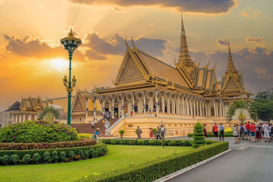 The ornate golden spires and classic Khmer architecture of the Royal Palace complex under a blue sky in Phnom Penh