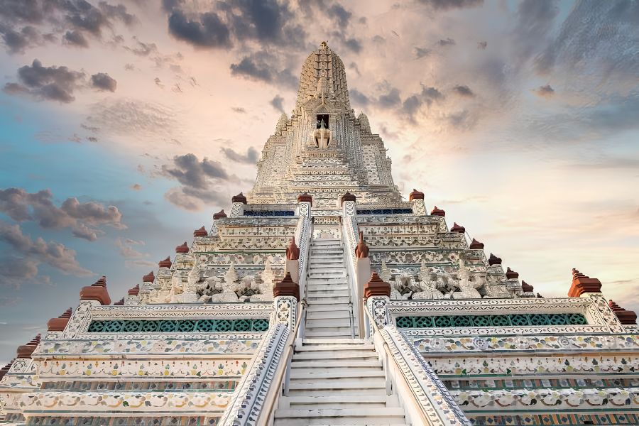 Close-up of intricate colorful porcelain mosaic patterns on the central prang tower of Wat Arun in Bangkok