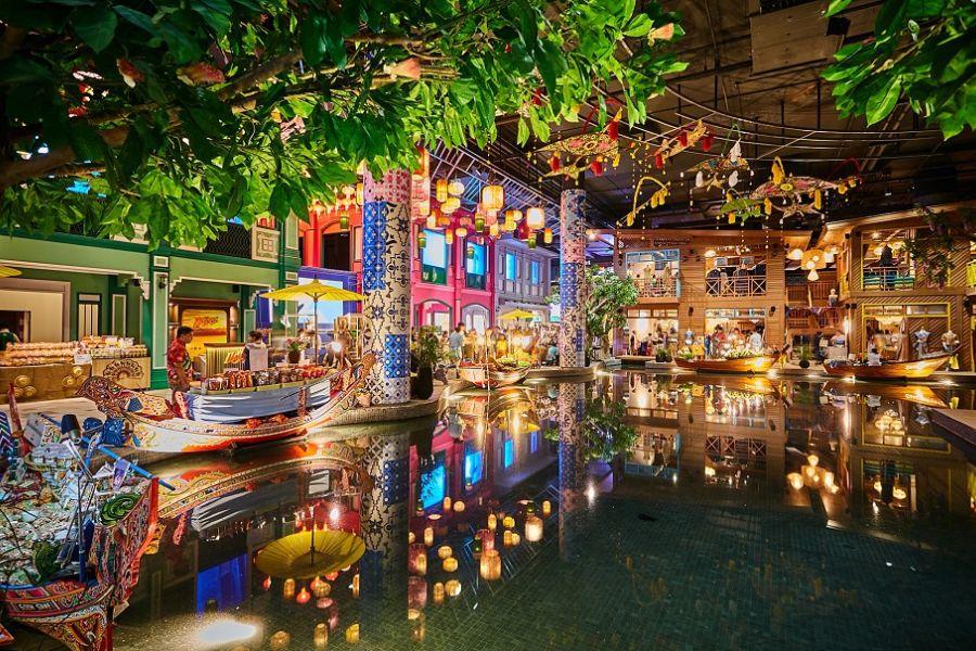 Indoor wooden boats serving traditional street food inside the SookSiam cultural hall at ICONSIAM in Bangkok