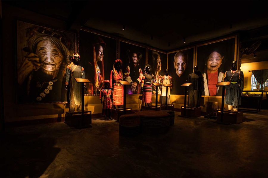Exhibition room inside the Precious Heritage Museum showcasing authentic ethnic tribal costumes and portrait photography by Rehahn