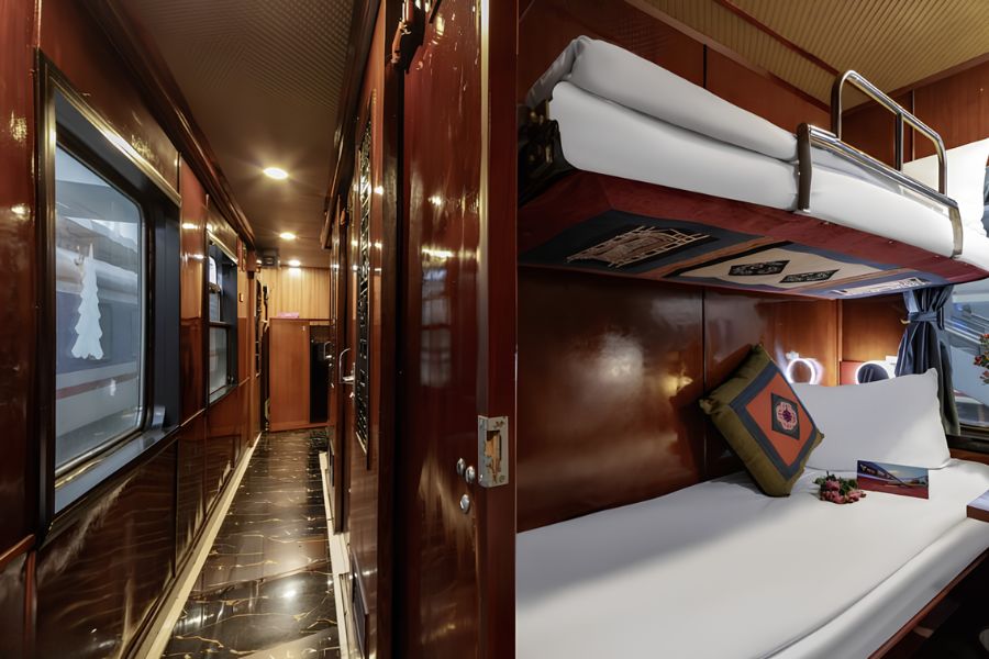 Traveller preparing a sleeping berth inside an overnight train cabin in Vietnam