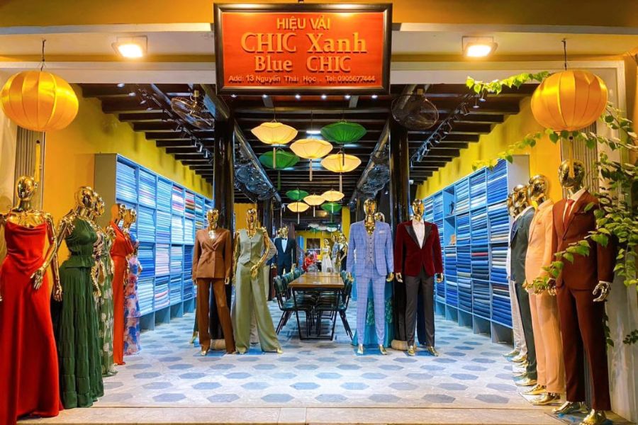 Tailored suits, dresses and shirts displayed inside Blue Eye Tailor in Hoi An