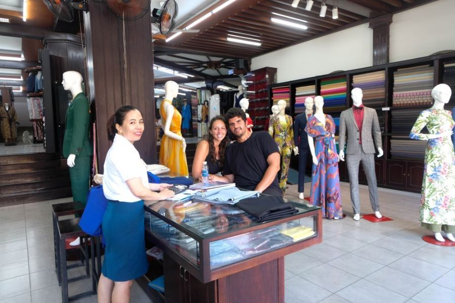 Tailor taking measurements for a custom suit at Tony The Tailor in Hoi An